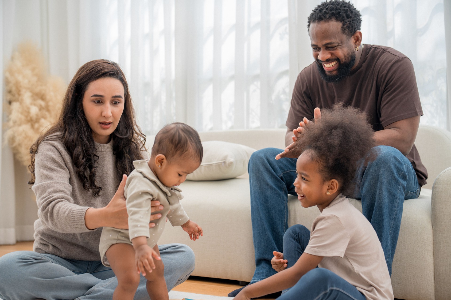 Family enjoying playtime together in a cozy living room with laughter and bonding moments
