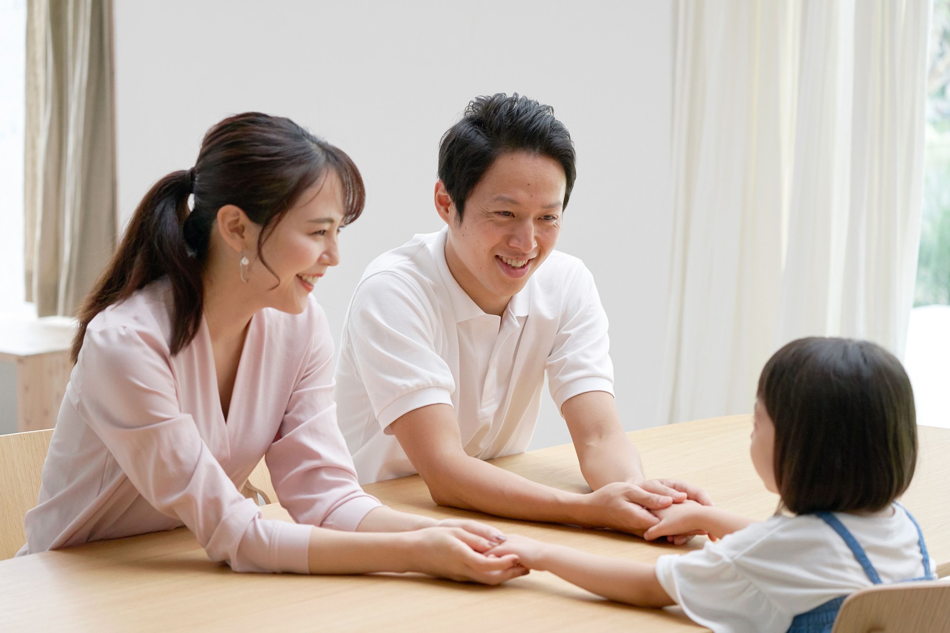 Asian parents talking with their daughter at home